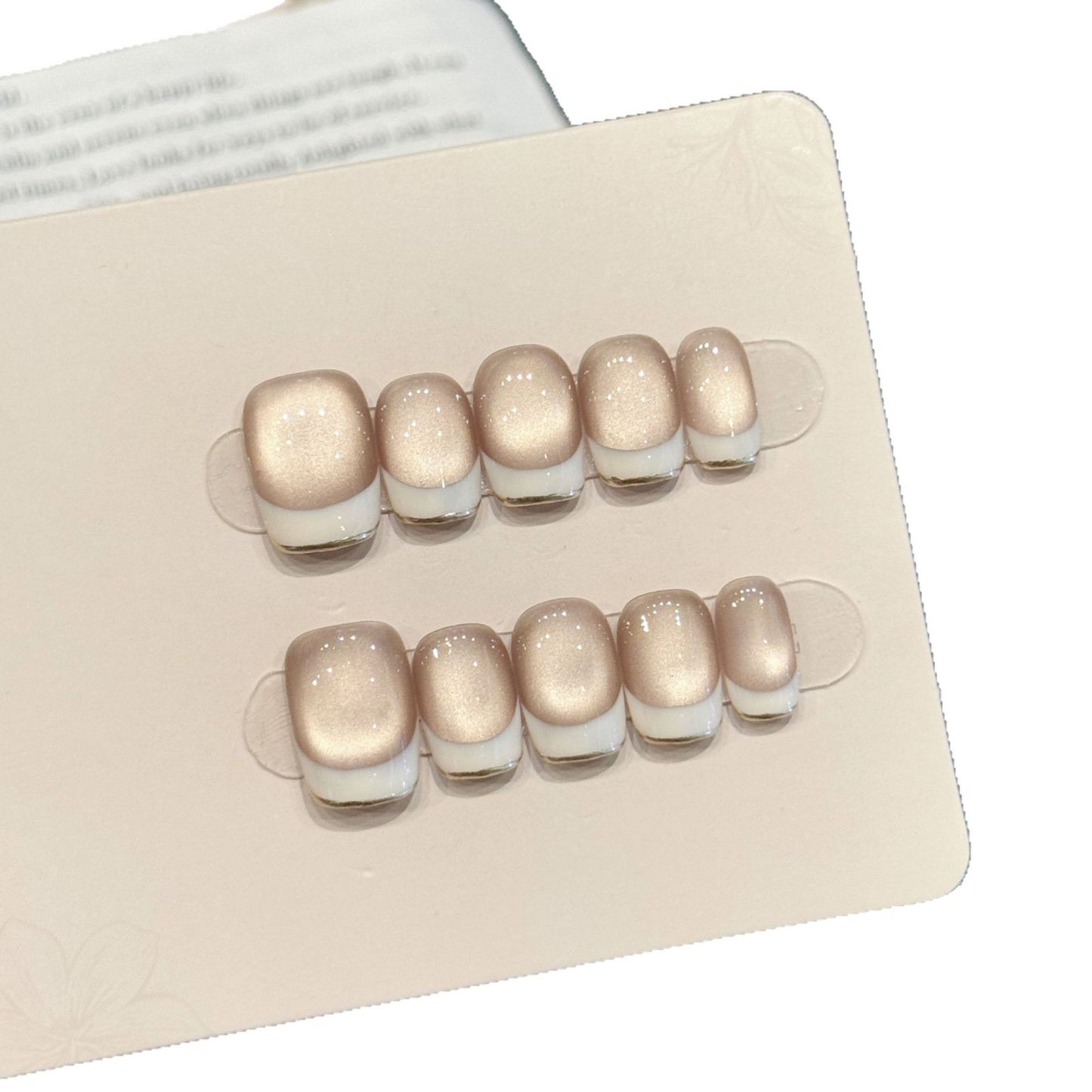 Skin-flattering nude glass-bead cat eye, white-edge French short press-on nails
