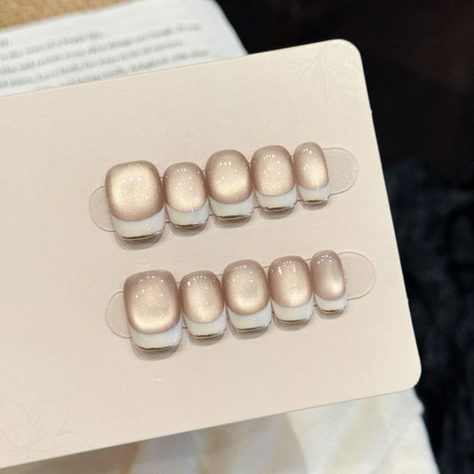 Skin-flattering nude glass-bead cat eye, white-edge French short press-on nails